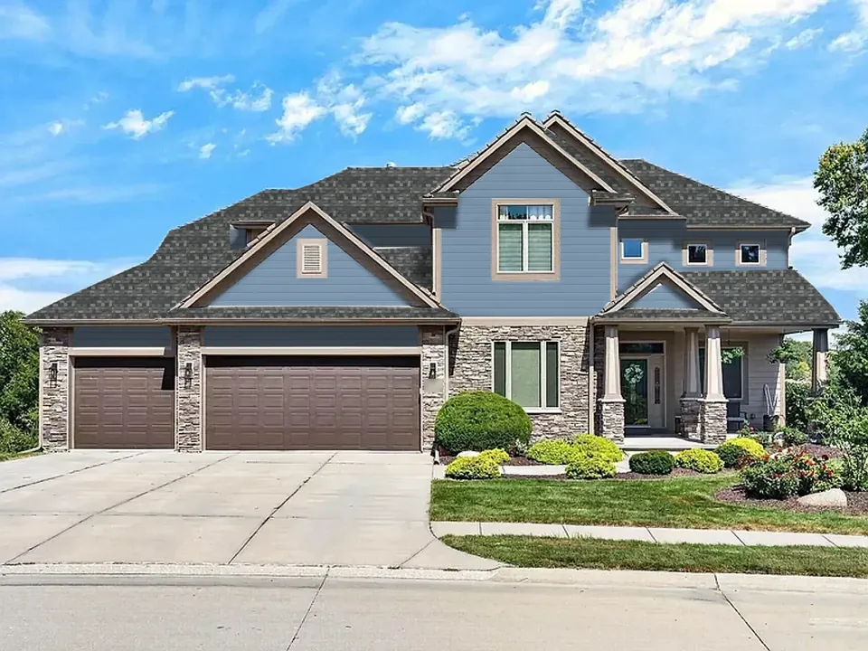 The same sample home with the Classic Refresh look: A grey roof with timeless blue lap siding.