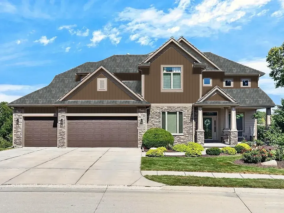 The same sample home with the Modern Prairie look: A charcoal slate roof over deep wood-tone panels.